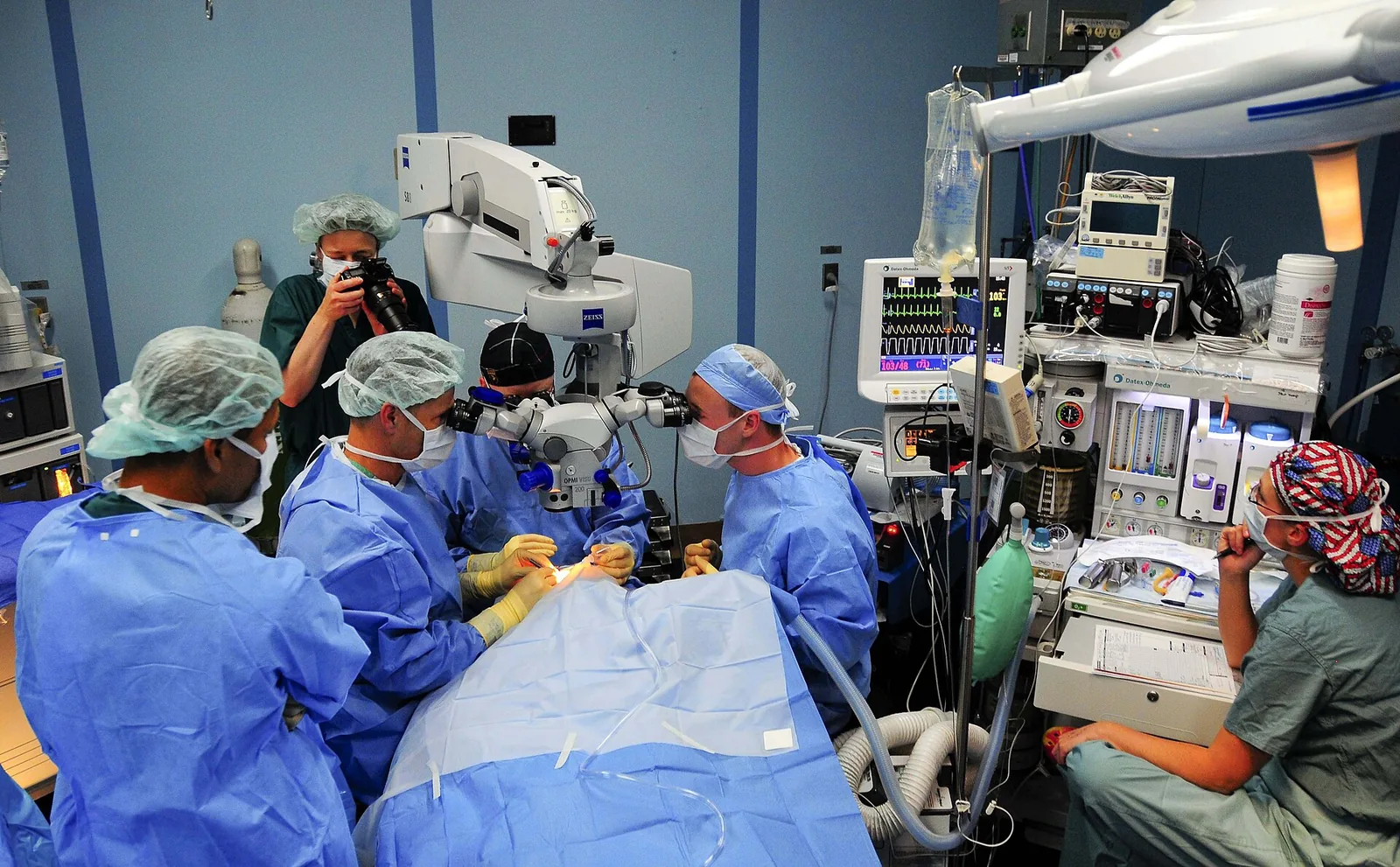 Ê-kíp phẫu thuật mắt dùng kính hiển vi phẫu thuật hai đầu quan sát trên tàu bệnh viện USNS Mercy (Philippines, 2008). Ảnh: U.S. Navy / Joshua Valcarcel / Wikimedia Commons, Public domain